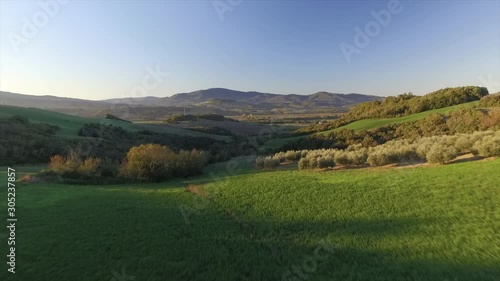 4k aerial  drone low fly footage over the green Tuscany countryside near Volterra. photo