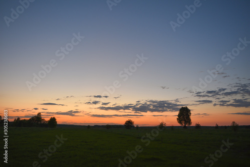 Summer sunset over a mown field