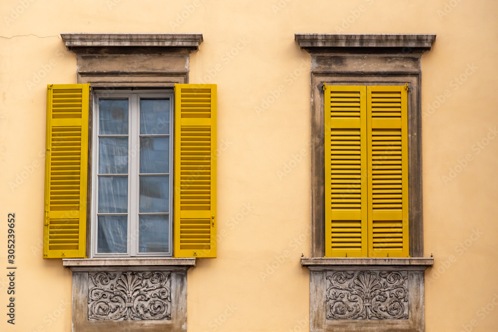 windows with yellow shutters and walls, Europe