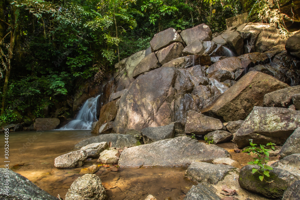 Kathu Waterfall in the tropical forest area In Asia, suitable for walks, nature walks and hiking, adventure photography Of the national park Phuket Thailand,Suitable for travel and leisure. Kathu Waterfall in the tropical forest area In Asia, suitable for walks, nature walks and hiking, adventure photography Of the national park Phuket Thailand,Suitable for travel and leisure.