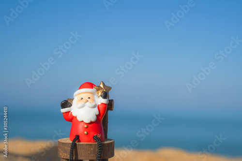Christmas Santa hold star.on the beach are texture Nature background creative bokeo tropical layout made at phuket Thailand