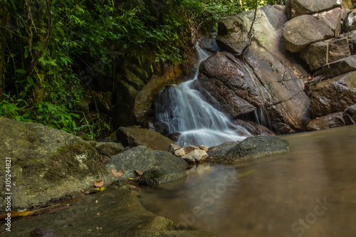 Fototapeta Naklejka Na Ścianę i Meble -  Kathu Waterfall in the tropical forest area In Asia, suitable for walks, nature walks and hiking, adventure photography Of the national park Phuket Thailand,Suitable for travel and leisure.