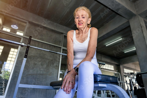 Senior woman Caucasian leg Pain during training at fitness gym.