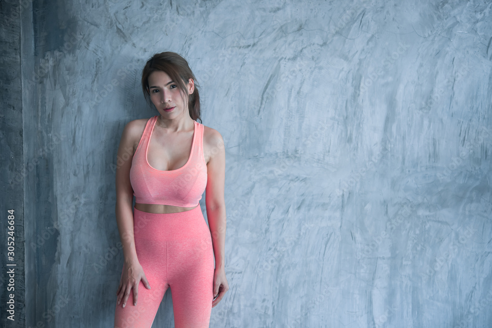 Close up asian beautiful sport girl on wall of gym,Thailand love health,Slim woman workout concept