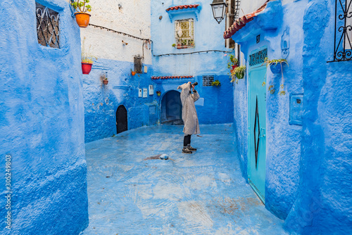 Female photographer in Chefchaouen the Blue city of Morocco