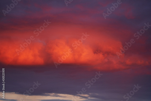 evening clouds lit by the setting sun. background. © Aleksandr
