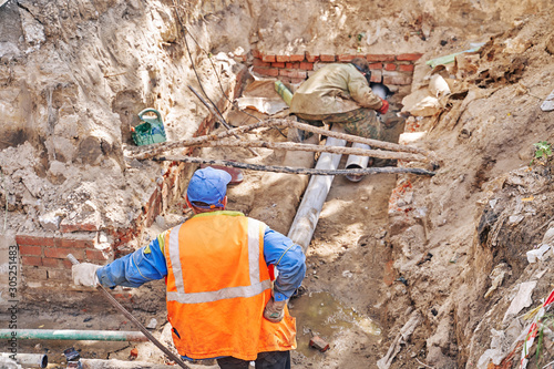 accident on the underground heating main. work crew repair damage