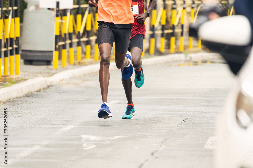 Marathon runners. Marathon running race in city streets. Marathon runners. Marathon running race in city streets.