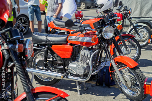 several retro motorcycles at an auto show