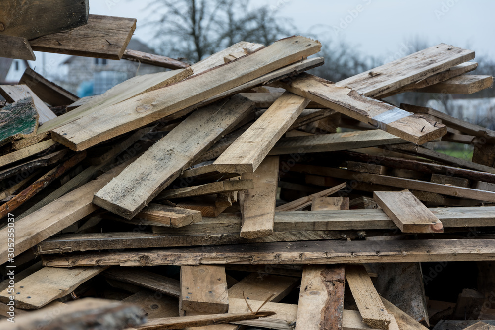 Dump of broken boards. Unnecessary trash. The removed floors are piled in a heap.