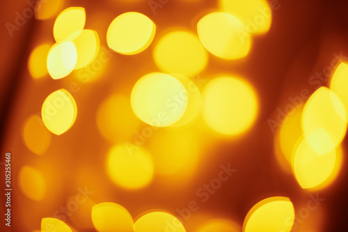 Background of golden lights in a bokeh. Defocused abstract blurred lights