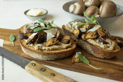 Food photography of a crostini toasted bread with sautéed mushrooms on mushroom paté