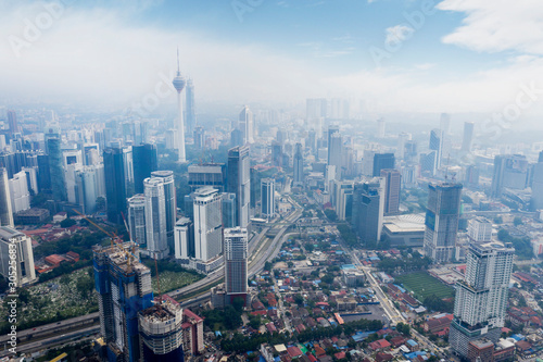 Obraz na płótnie KUALA LUMPUR - Malaysia. November 12, 2019: Aerial view of KL tower in Kuala Lumpur CBD area shot at midday over blue sky w salonie