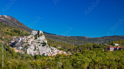 A view of the ancient village of Cerro al Volturno, surrounded by green woods and mountains. The Pandone castle stands on top of the hill, on a rock spur. Isernia, Molise, Italy. © Ragemax