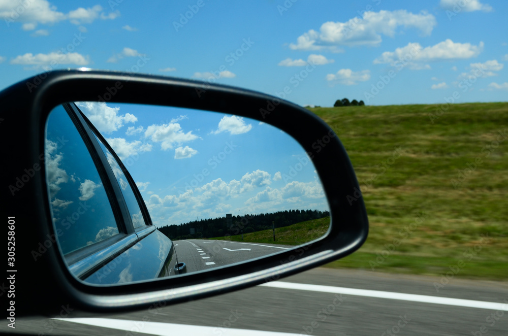 Car mirror on the road
