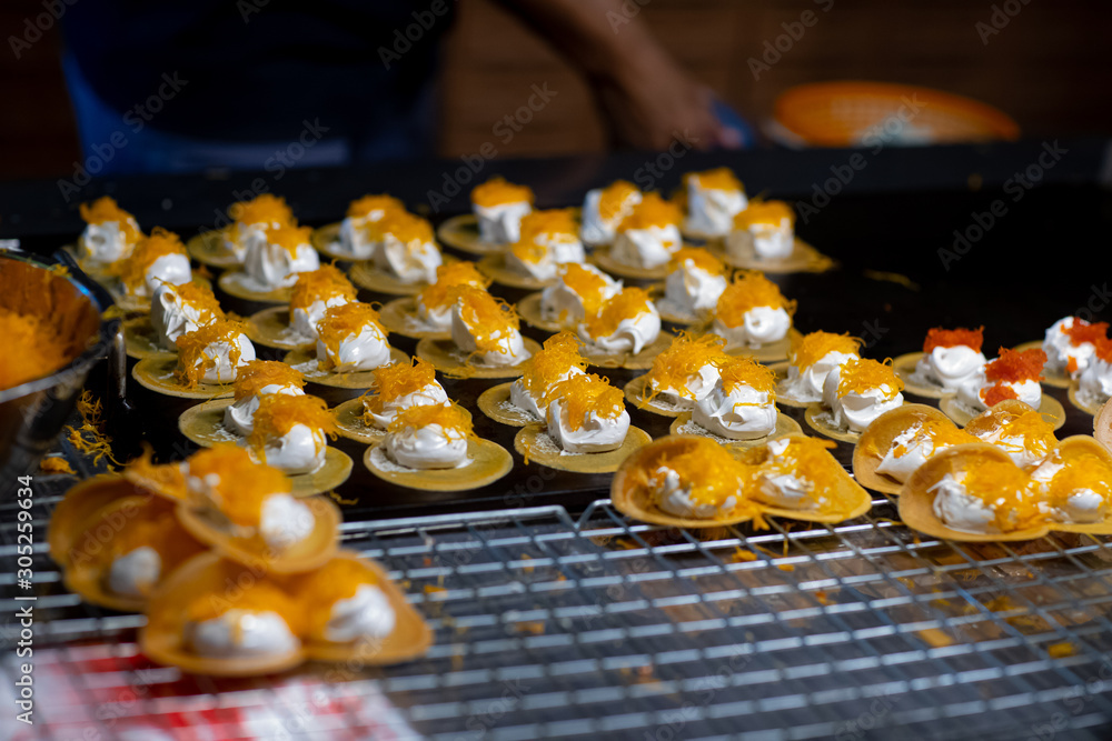 Traditional Thai desserts at Street food in thai temple festival fair (Thai Crispy Pancakes)