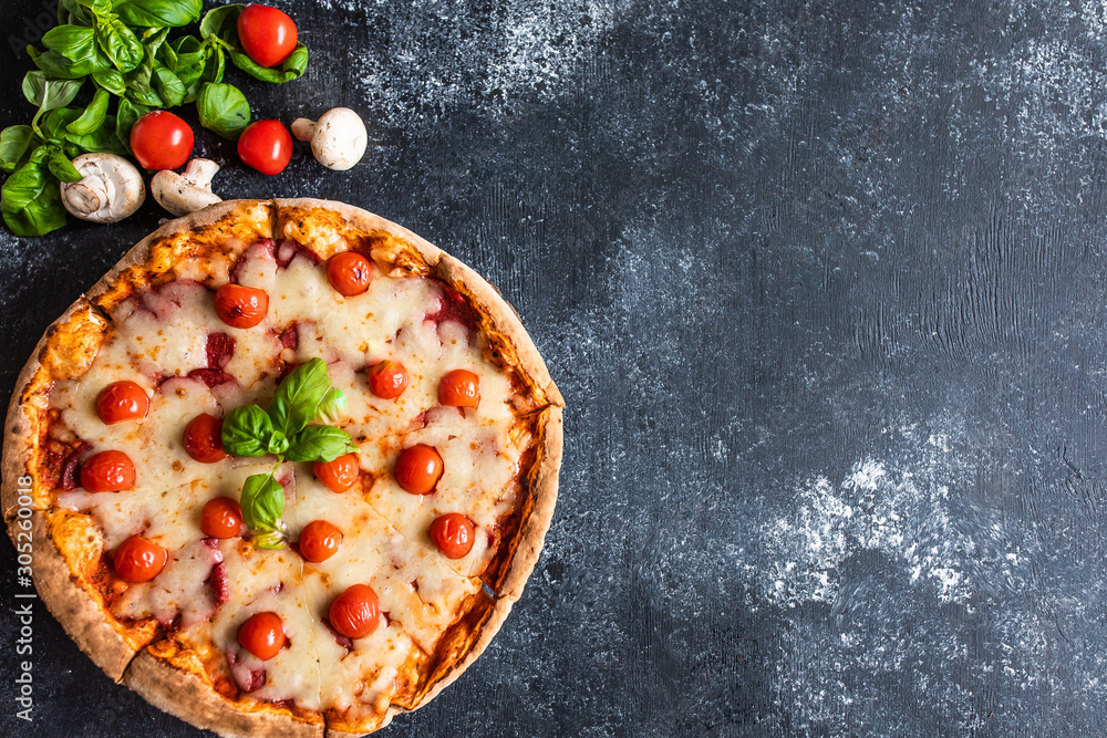 Delicious bright pizza on a dark background
