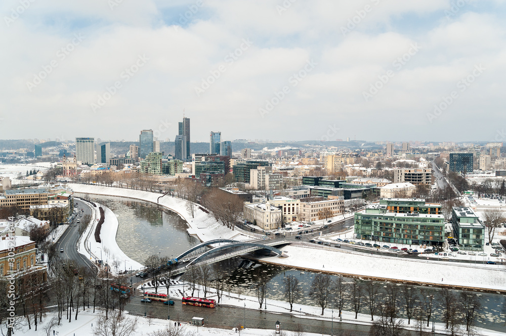 Winter snowy day in Vilnius, Gediminas Tower with view of the River and the embankment.