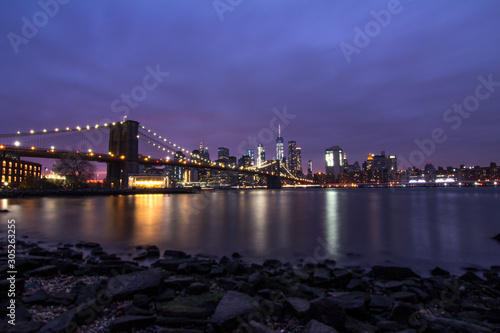 Sunset over Manhattan in New York City with a view on the Brooklyn Bridge.