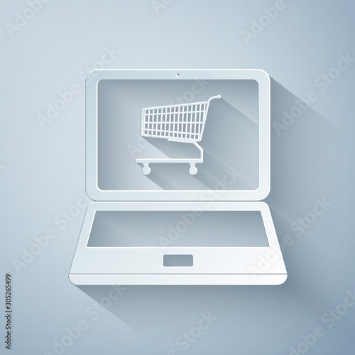 Paper cut Online shopping concept. Shopping cart on screen laptop icon isolated on grey background. Concept e-commerce, online business marketing. Paper art style. Vector Illustration