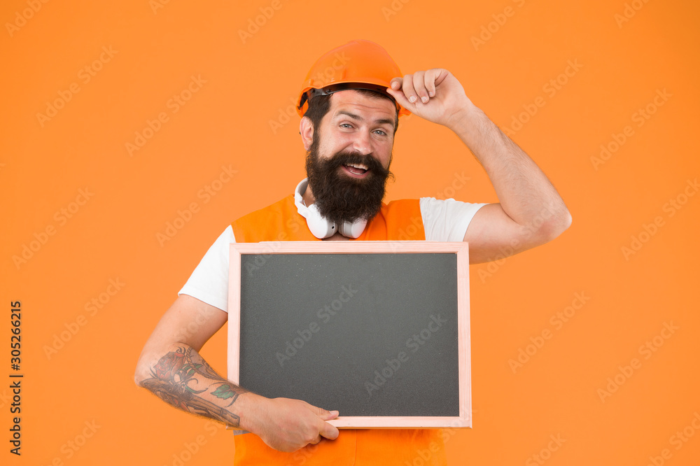 Builder in helmet. Install and repair pipes and fittings of water supply. Man hard hat hold chalkboard copy space. Announcing services. Foreman builder concept. Worker builder bearded face Builder in helmet. Install and repair pipes and fittings of water supply. Man hard hat hold chalkboard copy space. Announcing services. Foreman builder concept. Worker builder bearded face
