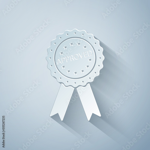 Paper cut Approved or certified medal badge with ribbons icon isolated on grey background. Approved seal stamp sign. Paper art style. Vector Illustration