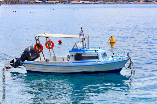 View of a small rescue boat with a powerful motor on the background of the beach coastline. photo