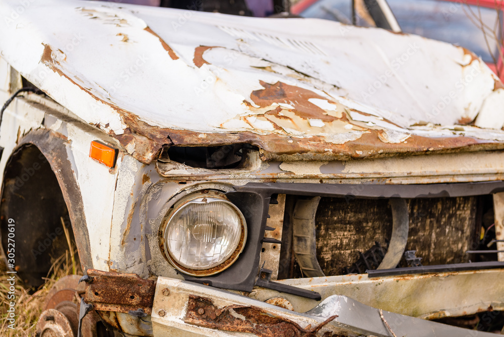 Fototapeta premium Old broken, rusting car. Rusty wrecked car. Car after the accident.