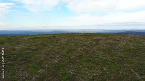 Aerial, drone view, towards the Kaarnepaa fell, in the Urho Kekkonen national park, on a partly sunny, summer day, in Lapland, Finland photo