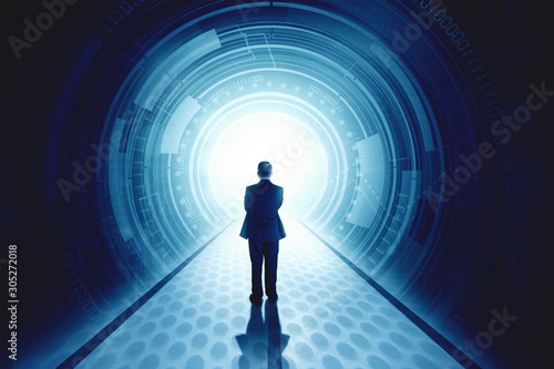Rear view of businessman standing in front of a futuristic tunnel