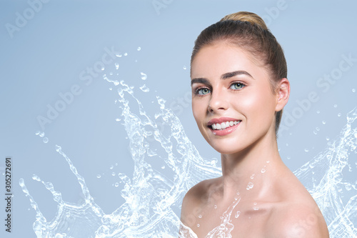 Young beautiful woman portrait with water splash