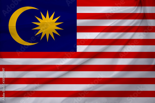 photo of the beautiful colored national flag of the modern state of Malaysia on textured fabric, concept of tourism, emigration, economy and politics, closeup