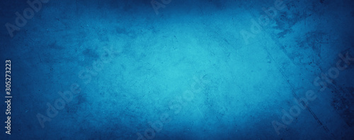 Blue textured paper or concrete wall background. Dark edges. Copy space