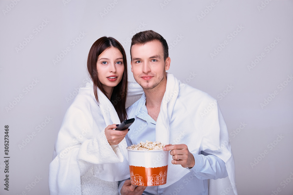 Man and woman watching tv and eating popcorn snack. Man and woman watching tv and eating popcorn snack.