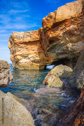 Beach of Spilies or Kitrenosi with sea caves near Rethimno, Crete, Greece.