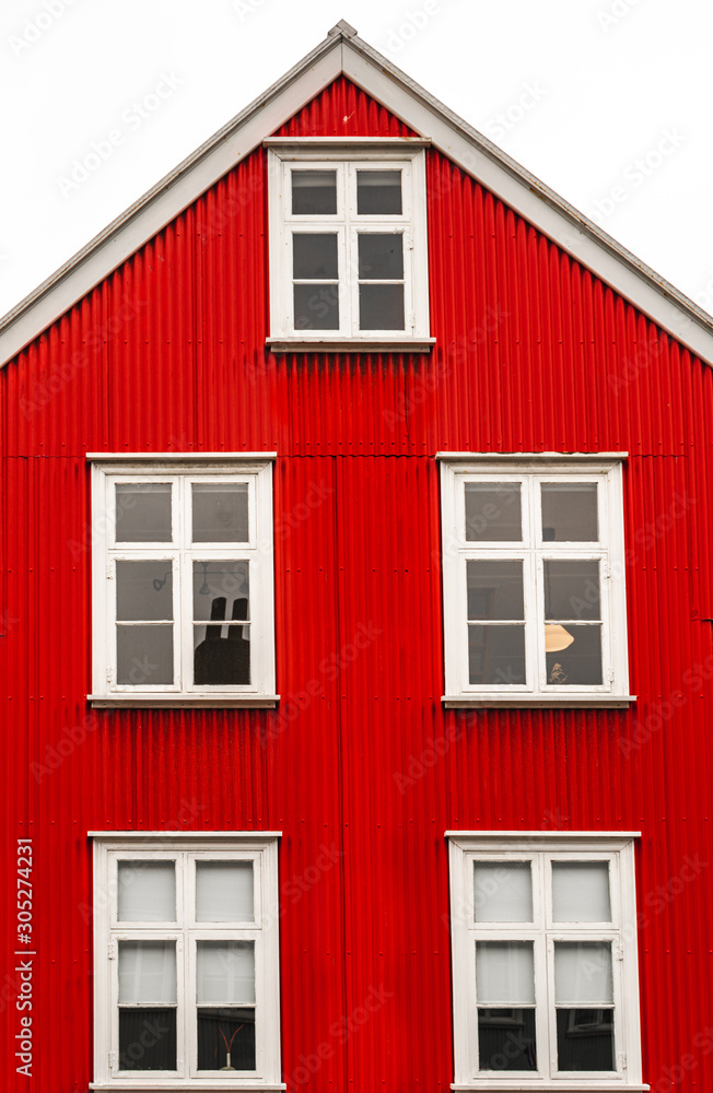 Street shot in Reykjavik. Traditional red house. Red facade Street shot in Reykjavik. Traditional red house. Red facade