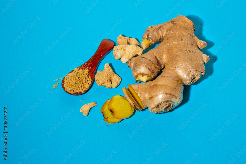 Fototapeta premium Ripe ginger root and ground on blue.
