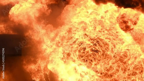 Big real fire of gas and oil explosion bursting through air.The building was burnt down.infernal fire in an industrial factory with big flame and smoke. Looping Fire Flames. Fire wall in slow motion.