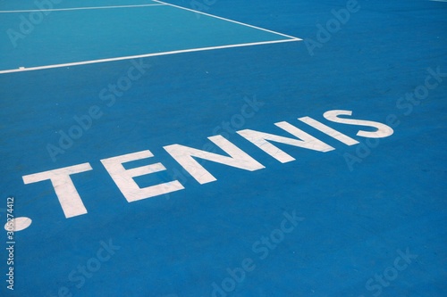 Word tennis written on tennis court