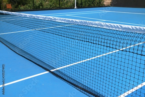 Tennis net on blue court