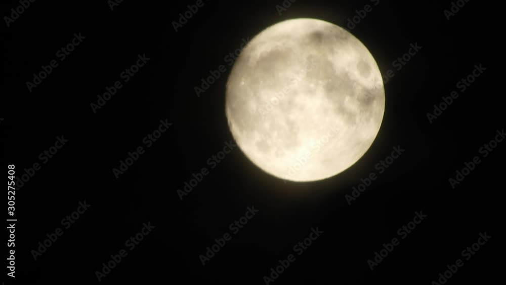 Full moon at night with cloud real time. 4k video full moon in the black sky. Clouds passing by moon at night. night sky with cloudy weather Full moon at night with cloud real time. 4k video full moon in the black sky. Clouds passing by moon at night. night sky with cloudy weather