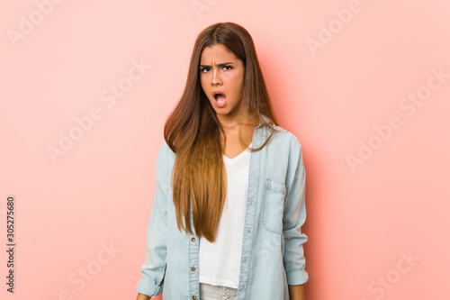 Fotografi Young slim woman screaming very angry and aggressive.