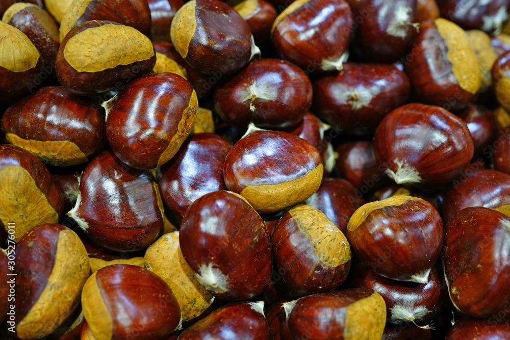 Fresh chestnuts in the shell at a farmers market Fresh chestnuts in the shell at a farmers market