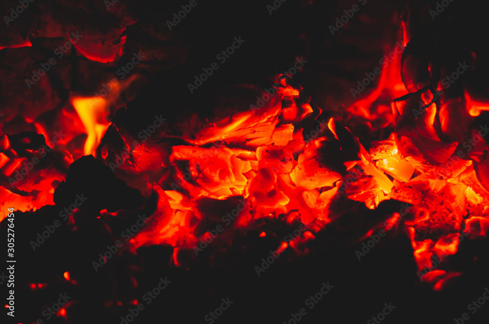 Fototapeta premium Beautiful red bright coals of bonfire. Close-up.