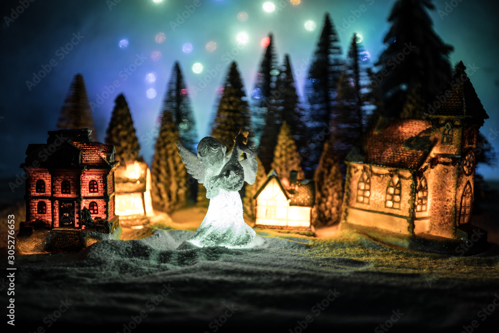 New Year miniature house in the snow at night with fir tree. New Year miniature house in the snow at night with fir tree.