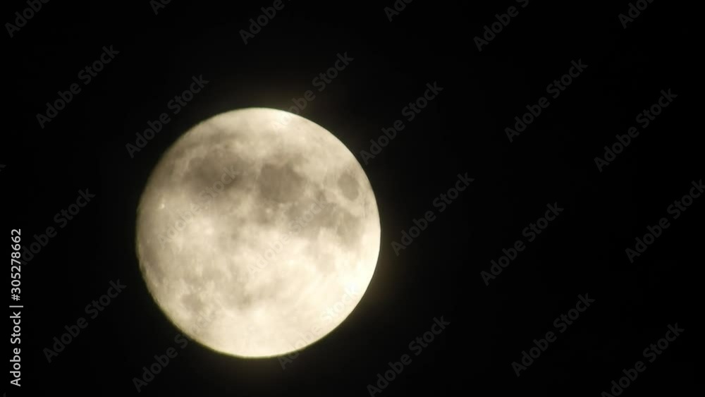 Full moon at night with cloud real time. 4k video full moon in the black sky. Clouds passing by moon at night. night sky with cloudy weather Full moon at night with cloud real time. 4k video full moon in the black sky. Clouds passing by moon at night. night sky with cloudy weather
