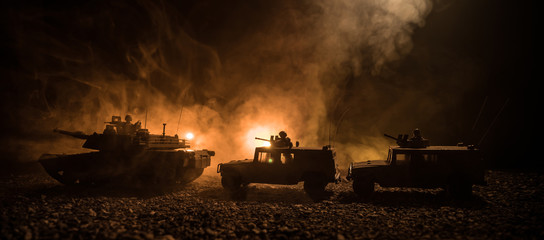 Military patrol car on sunset background. Army war concept. Silhouette of armored vehicle with soldiers ready to attack. Artwork decoration. Selective focus