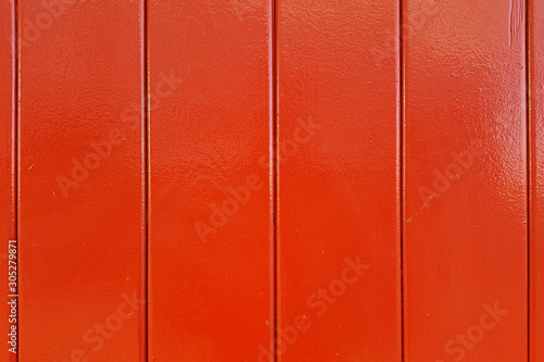 Wall of red wooden lacquered boards.