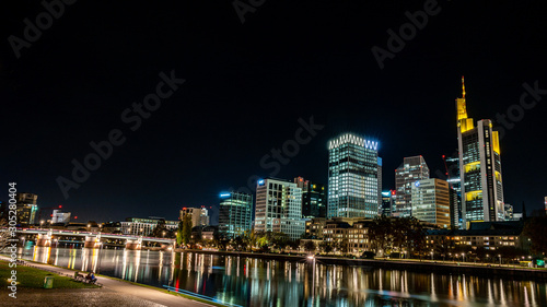 frankfurt skyline at night with colorful reflections in the main river, frankfurt am main, germany