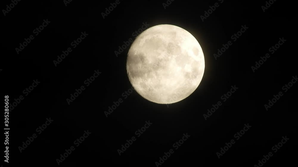 Full moon at night with cloud real time. 4k video full moon in the black sky. Clouds passing by moon at night. night sky with cloudy weather Full moon at night with cloud real time. 4k video full moon in the black sky. Clouds passing by moon at night. night sky with cloudy weather